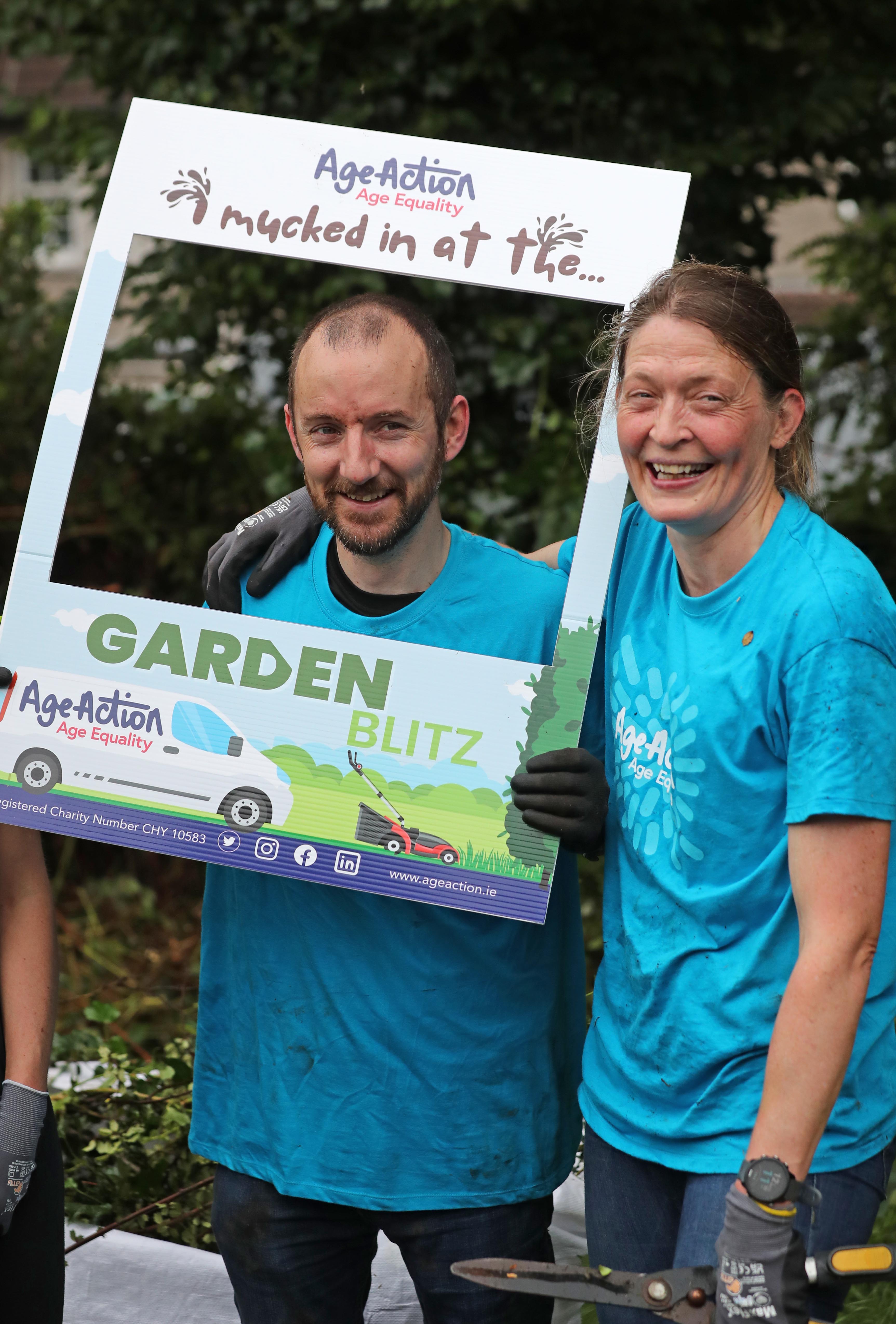 Volunteers tending to an older person's garden 