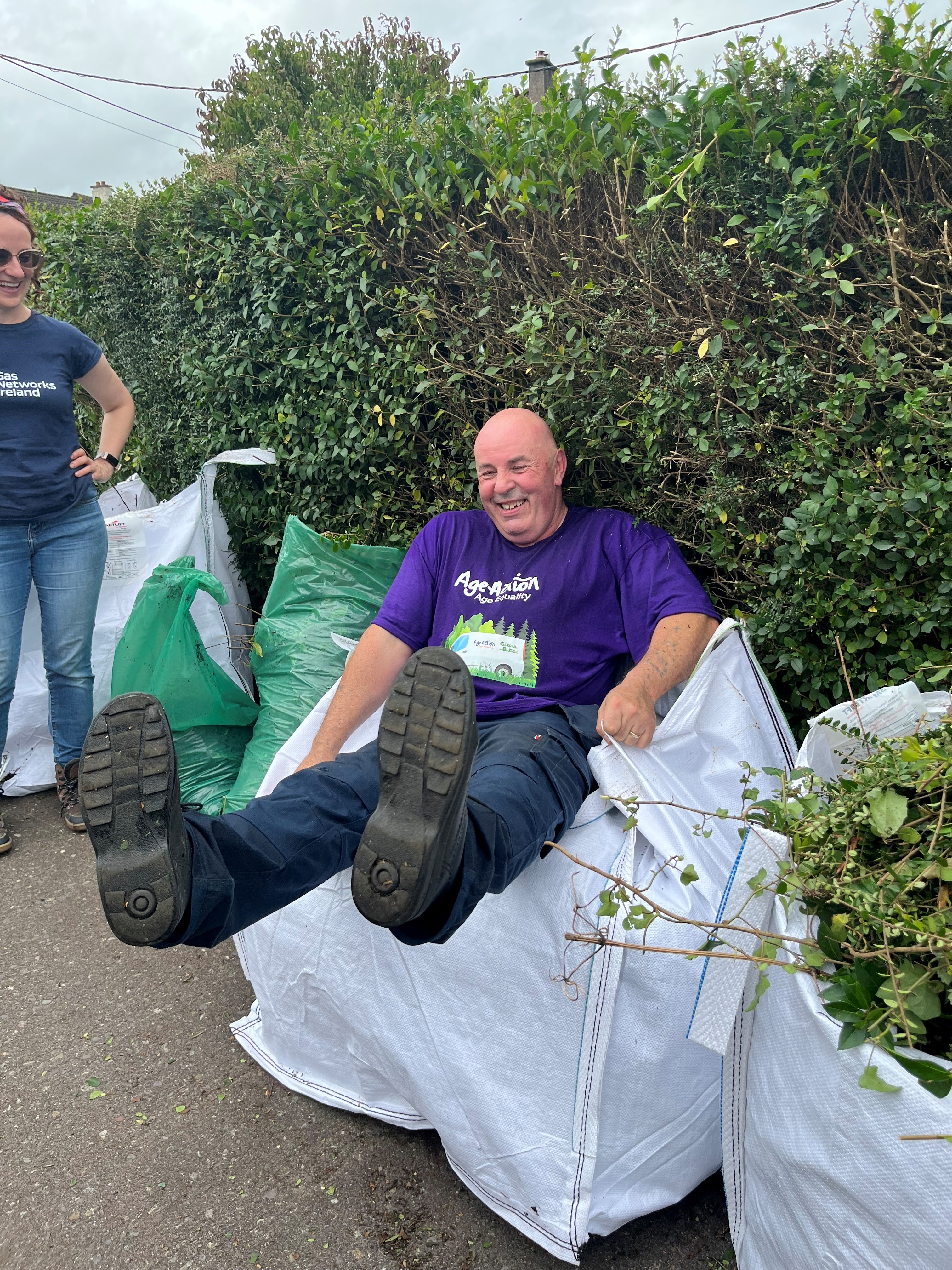 Volunteers tending to an older person's garden 